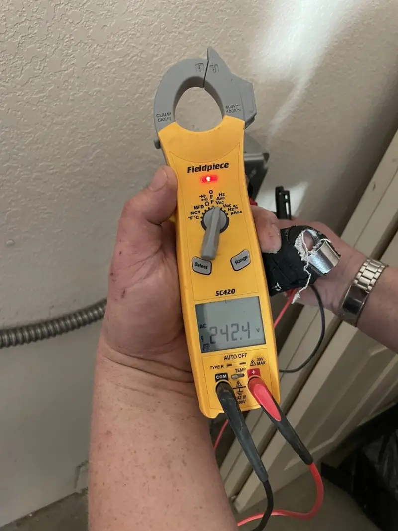 Voltage testing with clamp meter during Outlet Installation in Lincoln Village